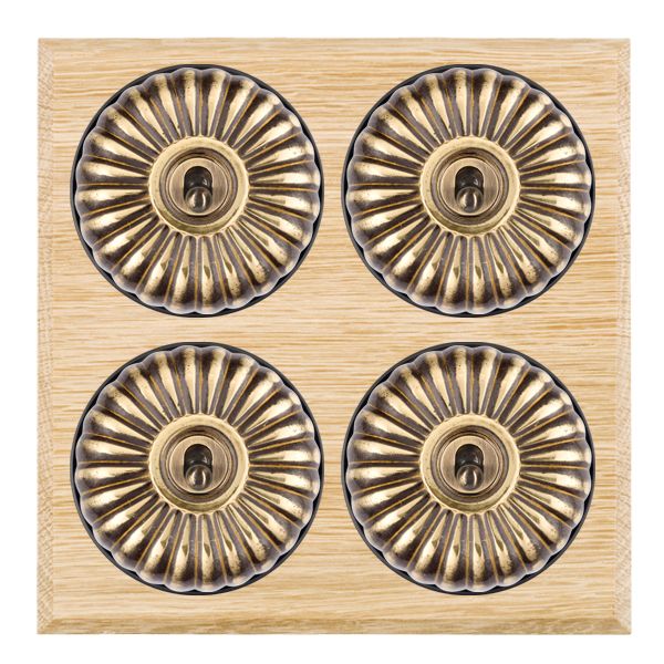 Bloomsbury Chamfered Light Oak 4 gang 20AX 2 Way Toggle Antique Brass Fluted Dome/Black Collar