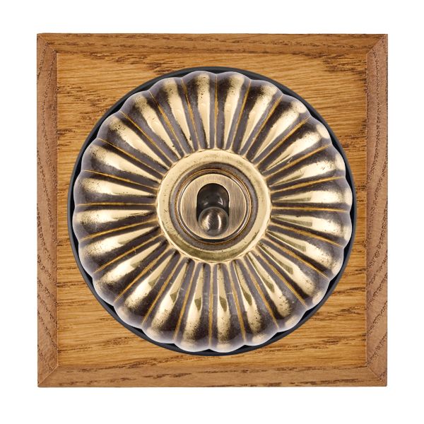 Bloomsbury Chamfered Medium Oak 1 gang 20AX 2 Way Toggle Antique Brass Fluted Dome/Black Collar