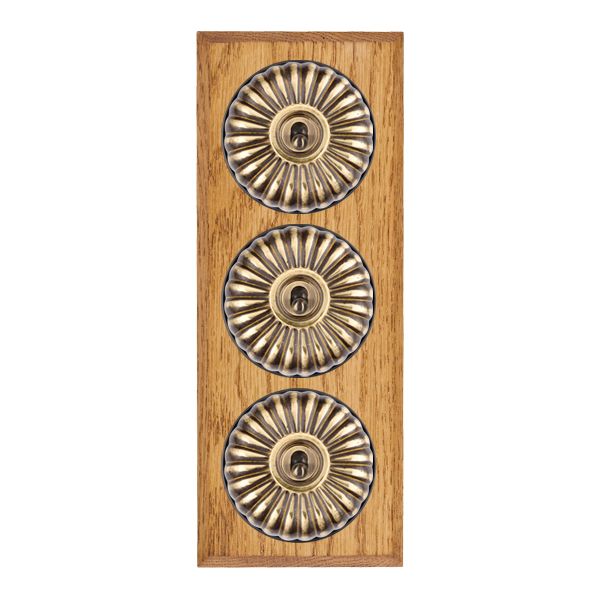 Bloomsbury Chamfered Medium Oak 3 gang 20AX 2 Way Toggle Antique Brass Fluted Dome/Black Collar