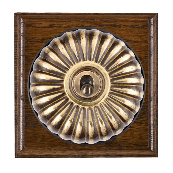 Bloomsbury Ovolo Dark Oak 1 gang 20AX 2 Way Toggle Antique Brass Fluted Dome/Black Collar