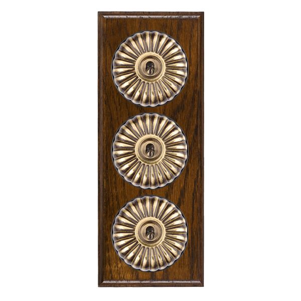 Bloomsbury Ovolo Dark Oak 3 gang 20AX 2 Way Toggle Antique Brass Fluted Dome/Black Collar