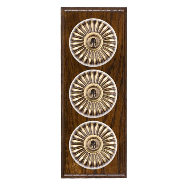 Bloomsbury Ovolo Dark Oak 3 gang 20AX 2 Way Toggle Antique Brass Fluted Dome/White Collar