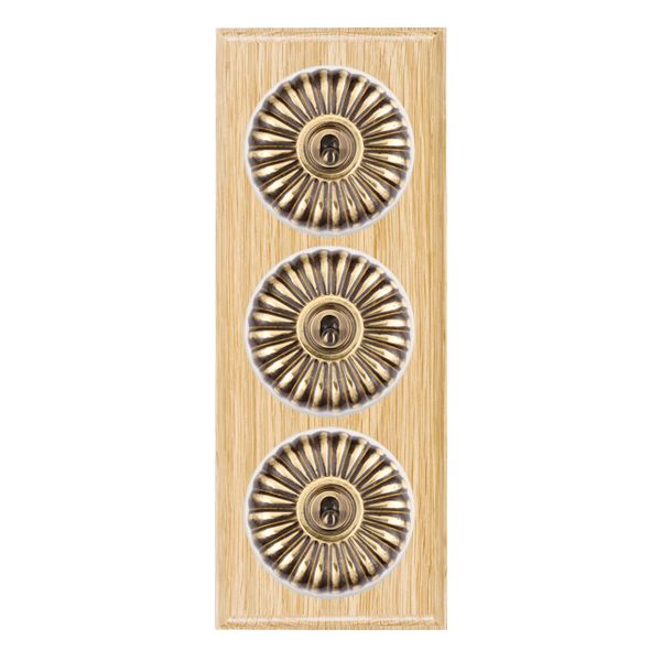 Bloomsbury Ovolo Light Oak 3 gang 20AX 2 Way Toggle Antique Brass Fluted Dome/White Collar