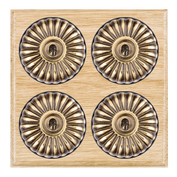 Bloomsbury Ovolo Light Oak 4 gang 20AX 2 Way Toggle Antique Brass Fluted Dome/Black Collar