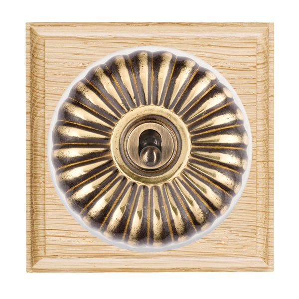 Bloomsbury Ovolo Light Oak 1 gang 20AX Intermediate Toggle Antique Brass Fluted Dome/White Collar