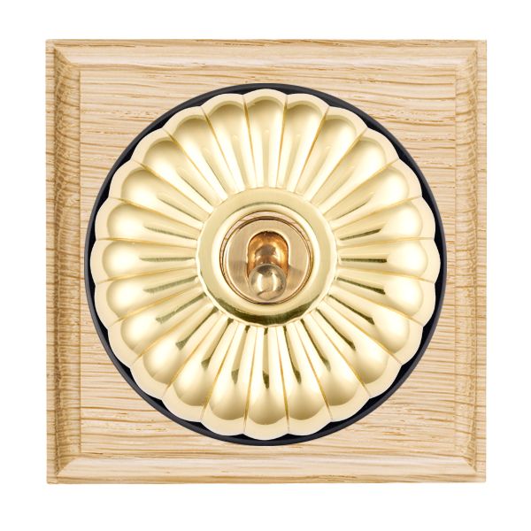 Bloomsbury Ovolo Light Oak 1 gang 20AX Intermediate Toggle Polished Brass Fluted Dome/Black Collar