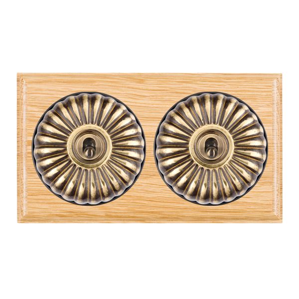 Bloomsbury Ovolo Light Oak 2 gang 20AX Intermediate Toggle Antique Brass Fluted Dome/Black Collar