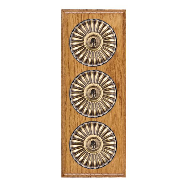 Bloomsbury Ovolo Medium Oak 3 gang 20AX 2 Way Toggle Antique Brass Fluted Dome/Black Collar