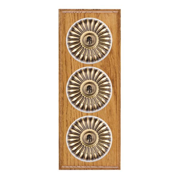 Bloomsbury Ovolo Medium Oak 3 gang 20AX 2 Way Toggle Antique Brass Fluted Dome/White Collar