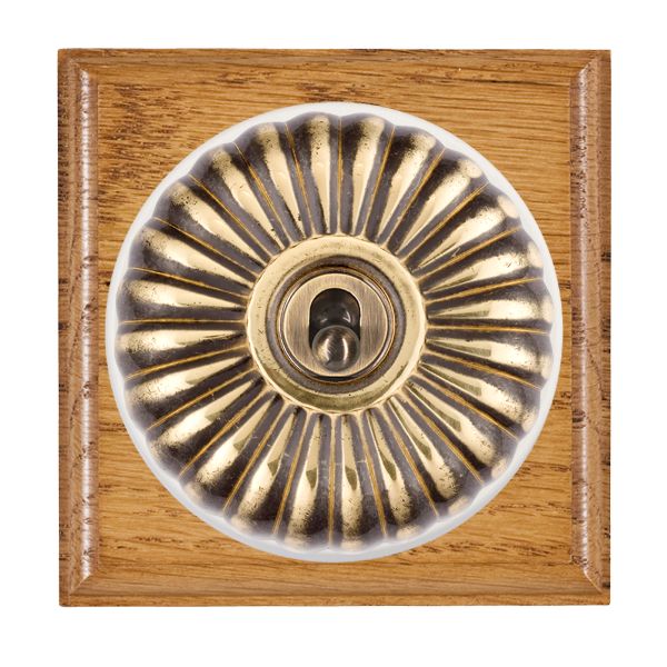 Bloomsbury Ovolo Medium Oak 1 gang 20AX Intermediate Toggle Antique Brass Fluted Dome/White Collar