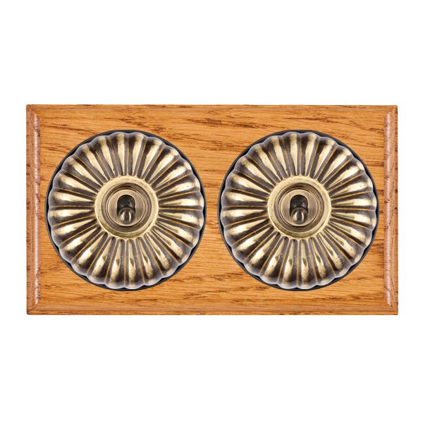 Bloomsbury Ovolo Medium Oak 2 gang 20AX Intermediate Toggle Antique Brass Fluted Dome/Black Collar