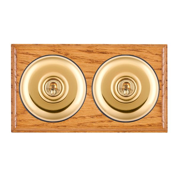 Bloomsbury Ovolo Medium Oak 2 gang 20AX Intermediate Toggle Polished Brass Plain Dome/Black Collar